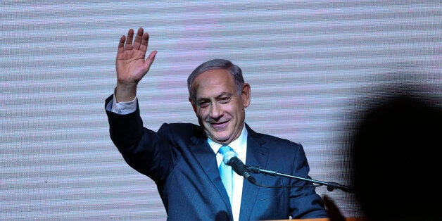 Israeli Prime Minister Benjamin Netanyahu greets supporters at the party's election headquarters In Tel Aviv. Wednesday, March 18, 2015. Exit polls from Israelâs national elections showed Prime Minister Benjamin Netanyahuâs Likud party nearly deadlocked with Isaac Herzogâs center-left Zionist Union. (AP Photo/Oded Balilty)