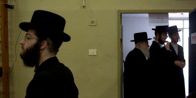 Ultra-Orthodox Jews line up to vote in Bnei Brak, Israel, Tuesday, March 17, 2015. Israelis are voting in early parliament elections following a campaign focused on economic issues such as the high cost of living, rather than fears of a nuclear Iran or the Israeli-Arab conflict. (AP Photo/Oded Balilty)
