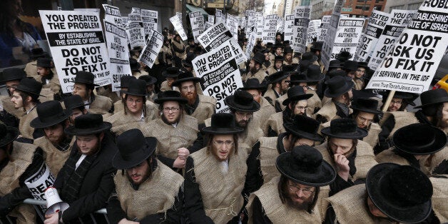 NEW YORK, NY - DECEMBER 24: Hundreds of Orthodox Jewish students marched to the Israeli Consulate in New York City to protest against the Israel's Middle East politics and recent Israel's law change such as conscription on December 24, 2013. (Photo by Bilgin Sasmaz/Anadolu Agency/Getty Images)