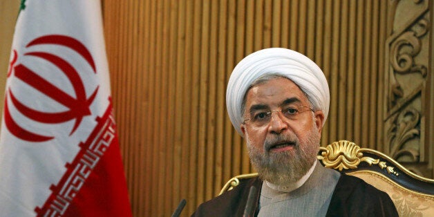 FLE - In this file photo taken Monday, Sept. 22, 2014, Iranian President Hassan Rouhani briefs media prior to departing Mehrabad airport to attend the United Nations General Assembly, in Tehran, Iran. Rouhani said Sunday, Jan. 4, 2015, that ongoing nuclear negotiations with world powers are a matter of "heart," not just centrifuges ahead of talks next week in Geneva. (AP Photo/Vahid Salemi, File)