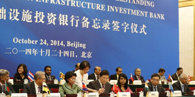 BEIJING, CHINA - OCTOBER 24: Chinese Finance Minister Lou Jiwei (C) signs the agreement establishing the Asian Infrastructure Investment Bank at the Great Hall of the People on October 24, 2014 in Beijing, China. Twenty-one countries including China, India, Pakistan and Singapore had been expected to sign the agreement today establishing the $57 billion bank. A number of other Asian nations including South Korea, Indonesia and Australia declined to sign on for the time being reportedly under lobbying by the U.S. government. (Photo by Takaki Yajima-Pool/Getty Images)