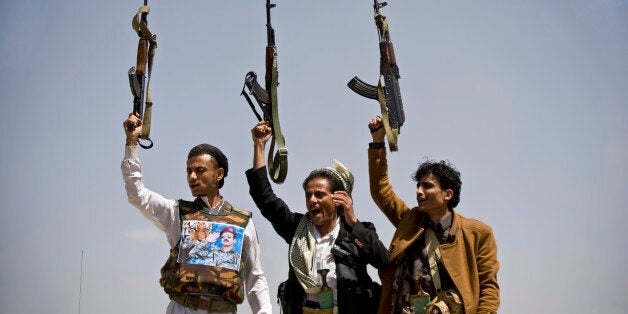 Supporters of Ahmed Ali Abdullah Saleh, the son of Yemeni former President Ali Abdullah Saleh, hold their weapons as they chant slogans during a demonstration demanding presidential elections be held and the younger Saleh run for the office, in Sanaa, Yemen, Tuesday, March 10, 2015. (AP Photo/Hani Mohammed)