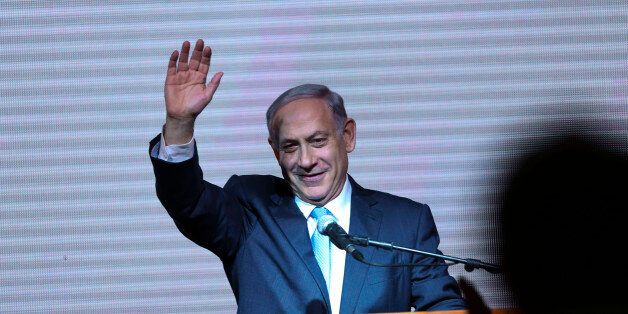 FILE - In this March 18, 2015, file photo, Israeli Prime Minister Benjamin Netanyahu greets supporters at the party's election headquarters in Tel Aviv. Netanyahu apologized to Israel's Arab citizens on Monday, March 23, 2015, for remarks he made during last week's parliament election that offended members of the community. (AP Photo/Oded Balilty, File)