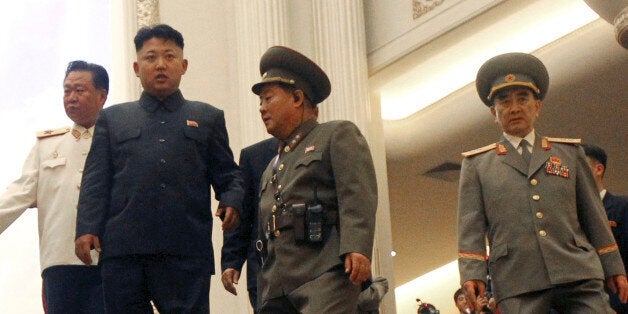 FILE - In this July 27, 2013 file photo, North Korean leader Kim Jong Un, second left, flanked by Yang Hyong Sop, right, vice president of the Presidium of North Korea's parliament, and Choe Ryong Hae, vice Marshal, left, as he tours the newly opened Fatherland Liberation War Museum as part of celebrations for the 60th anniversary of the Korean War armistice in Pyongyang, North Korea. A campaign within the United Nations to haul North Korean leader Kim Jong Un before an international court for crimes against humanity has touched off a defensive fury in Pyongyang, where itâs being treated like a diplomatic declaration of war - an aggressive act aimed not only at shutting down prison camps but also at removing Kim and dismantling his familyâs three-generation cult of personality. (AP Photo/Wong Maye-E, File)