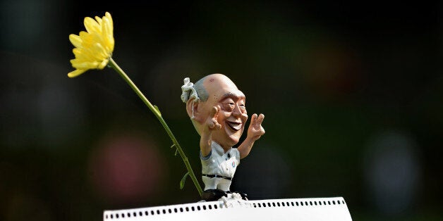 A Caricature of former Singapore prime minister Lee Kuan Yew is displayed during a rally at a free-speech park called Speakers' Corner in Singapore on June 8, 2013. Around 1,500 Singaporeans led by local bloggers attended a rally on June 8 to protest new government licencing rules for news websites that they say curtail freedom of expression. AFP PHOTO / ROSLAN RAHMAN (Photo credit should read ROSLAN RAHMAN/AFP/Getty Images)