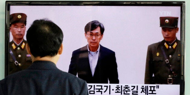 A South Korean man watches a TV screen reporting about South Korean Kim Kuk Gi, center, detained in North Korea, at the Seoul Railway Station in Seoul, South Korea, Friday, March 27, 2015. South Korea urged North Korea to immediately release two of its citizens detained in the country over alleged espionage charges, the latest in a series of arrests in the North of foreign nationals. The letters read "Detained Kim Kuk Gi, Choe Chun Gil." (AP Photo/Ahn Young-joon)