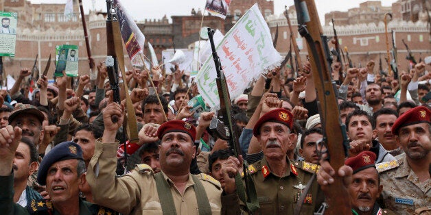 Shiite rebels, known as Houthis, hold up their weapons to protest against Saudi-led airstrikes, during a rally in Sanaa, Yemen, Thursday, March 26, 2015. Saudi Arabia bombed key military installations in Yemen on Thursday, leading a regional coalition in a campaign against Shiite rebels who have taken over much of the country and drove out the president. (AP Photo/Hani Mohammed)