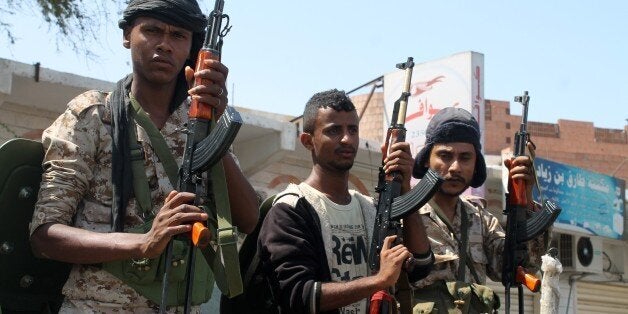 Yemeni soldiers and armed militiamen loyal to Yemeni President Abedrabbo Mansour Hadi, also known as the Popular Resistance Committees, stand guard near the airport in the southern city of Aden on March 19, 2015, during clashes with Yemeni special forces opposed to the country's president. The battle left five people dead and forced the international airport to close. The heavily armed troops, who are allied with Shiite militia in control of the capital Sanaa, advanced inside the airport perimeter but the Hadi loyalists managed to secure the runway, security sources said. AFP PHOTO / STR (Photo credit should read STR/AFP/Getty Images)