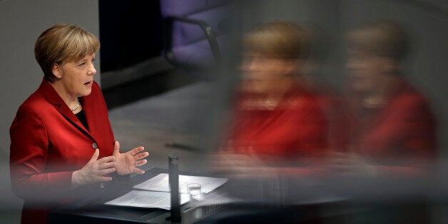 German Chancellor Angela Merkel gestures during her speech as part of a meeting of the German federal parliament, Bundestag, in Berlin, Germany, Thursday, March 19, 2015. The reflections are caused by windows at the visitors tribune. (AP Photo/Michael Sohn)