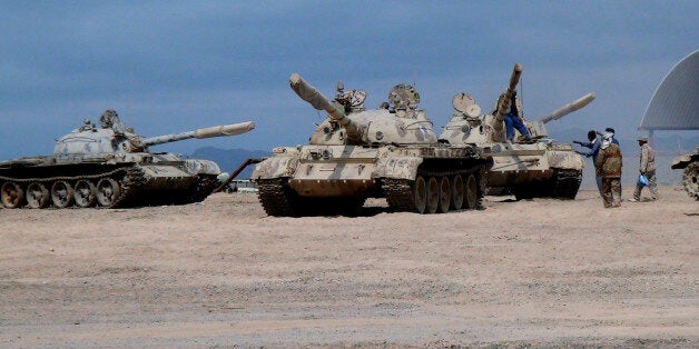 In this photo taken Tuesday, March 24, 2015, tanks seized recently by militiamen loyal to Yemen's President Abed Rabbo Mansour Hadi take positions at the al-Anad air base in the southern province of Lahej, 60 kilometers (35 miles) north of Aden, Yemen. Hadi fled the country by sea Wednesday on a boat from Aden, as Shiite rebels and their allies advanced on the southern port city of Aden, where he had taken refuge, captured his defense minister and seized the city's airport. (AP Photo/Wael Qubady)