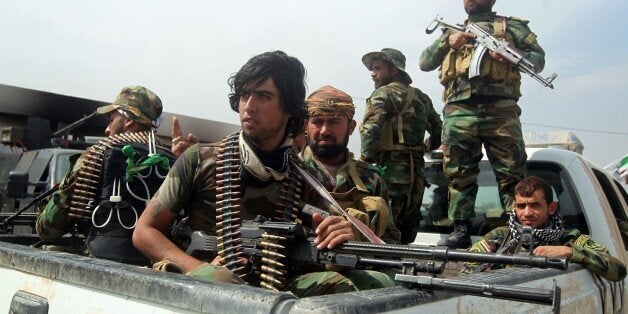 Members of Iraqi paramilitary Popular Mobilisation units, which are dominated by Shiite militias, take part in a military operation in the village of Albu Ajil, near the city of Tikrit, to regain control of the area from jihadists of the Islamic State (IS) group, on March 9, 2015. Some 30,000 Iraqi soldiers, police and the increasingly influential paramilitary Popular Mobilisation units, which are dominated by Shiite militias, have been involved in a week-old operation to recapture Tikrit, one of the jihadists' main hubs since they overran large parts of Iraq nine months ago. AFP PHOTO / AHMAD AL-RUBAYE (Photo credit should read AHMAD AL-RUBAYE/AFP/Getty Images)