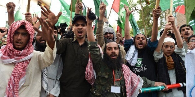 Pakistani activists march in support of the Saudi government at a protest in Quetta on March 30, 2015. Pakistan on March 29 evacuated more than 500 of its citizens from Yemen by jumbo jet and sent a naval frigate to rescue others stranded in the war-torn country, officials said. AFP PHOTO / Banaras KHAN (Photo credit should read BANARAS KHAN/AFP/Getty Images)