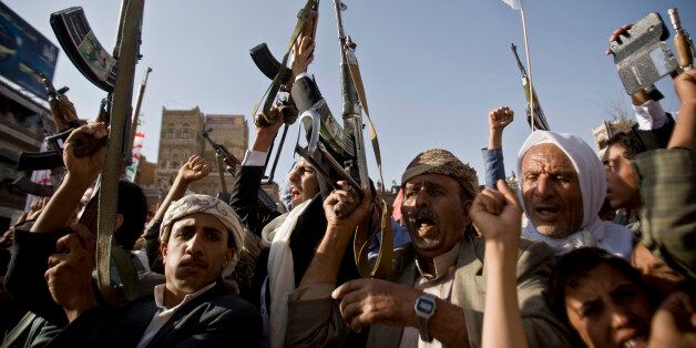 Shiite rebels, known as Houthis, hold up their weapons to protest against Saudi-led airstrikes, during a rally in Sanaa, Yemen, Wednesday, April 1, 2015. Saudi-led coalition warplanes bombed Shiite rebel positions in both north and south Yemen early Wednesday, setting off explosions and drawing return fire from anti-aircraft guns. (AP Photo/Hani Mohammed)
