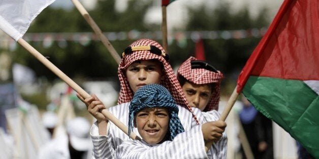 Palestinian children take part in an activity organised to mark Land Day on March 30, 2015 in Gaza City. The annual Land Day demonstrations are held to remember six Arab Israeli protesters who were shot dead by Israeli police and troops during mass demonstrations in 1976 against plans to confiscate Arab land in the Galilee. AFP PHOTO / MOHAMMED ABED (Photo credit should read MOHAMMED ABED/AFP/Getty Images)