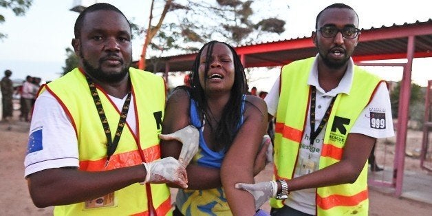 Paramedics help a student who was injured during an attack by Somalia's Al-Qaeda-linked Shebab gunmen on the Moi University campus in Garissa on April 2, 2015. At least 70 students were massacred when Somalia's Shebab Islamist group attacked a Kenyan university today, the interior minister said, the deadliest attack in the country since US embassy bombings in 1998. AFP PHOTO / CARL DE SOUZA (Photo credit should read CARL DE SOUZA/AFP/Getty Images)