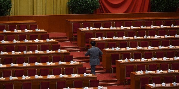 A delegate arrives for the closing ceremony of the Chinese People's Political Consultative Conference, an advisory body to the legislature, the National People's Congress (NPC), in Beijing's Great Hall of the People on March 13, 2015. The NPC closes its annual session on March 15. AFP PHOTO / Greg BAKER (Photo credit should read GREG BAKER/AFP/Getty Images)