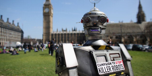 LONDON, ENGLAND - APRIL 23: A robot distributes promotional literature calling for a ban on fully autonomous weapons in Parliament Square on April 23, 2013 in London, England. The 'Campaign to Stop Killer Robots' is calling for a pre-emptive ban on lethal robot weapons that could attack targets without human intervention. (Photo by Oli Scarff/Getty Images)