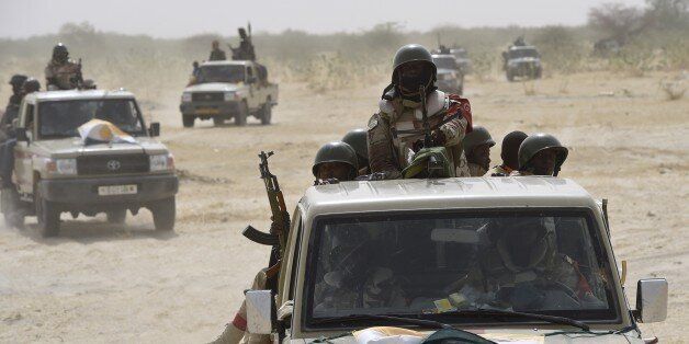 Nigerien army forces patrol in pickup trucks near Malam Fatori on April 3, 2015, after the town in north-eastern Nigeria was retaken from Boko Haram by troops from Chad and Niger. AFP PHOTO / PHILIPPE DESMAZES (Photo credit should read PHILIPPE DESMAZES/AFP/Getty Images)
