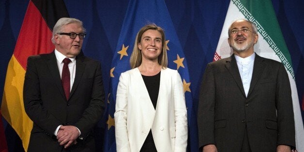 Iranian Foreign Minister Javad Zarif (R) waits to make a statement flanked by German Foreign Minister Frank Walter Steinmeier