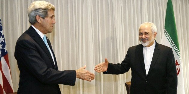 Iranian Foreign Minister Mohammad Javad Zarif shakes hands on January 14, 2015 with US State Secretary John Kerry in Geneva. Zarif said on January 14 that his meeting with US counterpart was vital for progress on talks on Tehran's contested nuclear drive. Under an interim deal agreed in November 2013, Iran's stock of fissile material has been diluted from 20 percent enriched uranium to five percent, in exchange for limited sanctions relief. AFP PHOTO / POOL / RICK WILKING (Photo credit should read RICK WILKING/AFP/Getty Images)