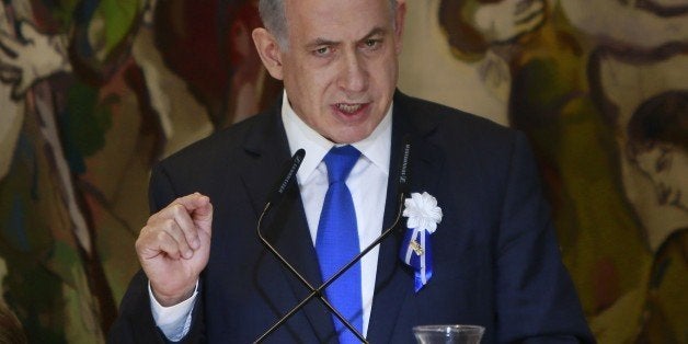 Israeli Prime Minister Benjamin Netanyahu gestures as he delivers a speech during an event following the first session of the