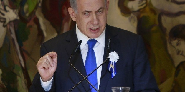 Israeli Prime Minister Benjamin Netanyahu gestures as he delivers a speech during an event following the first session of the newly-elected Knesset (Israel's Parliament) on March 31, 2015 in Jerusalem. AFP PHOTO / POOL / GALI TIBBON (Photo credit should read GALI TIBBON/AFP/Getty Images)