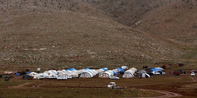 A general view shows a make-shift camp for displaced Iraqi people from the Yazidi community, who fled violence between Islamic State (IS) group jihadists and Peshmerga fighters in the northern Iraqi town of Sinjar, set up on Mount Sinjar on January 15, 2015. IS group has targeted Yazidis and other minorities in northern Iraq in a campaign that rights group Amnesty International said in a report amounted to ethnic cleansing, murdering civilians and enslaving others for a fate that some captives consider worse than death. IS militants have overrun swathes of Iraq since June 2014, declared a cross-border caliphate also encompassing parts of neighbouring Syria and carried out a litany of abuses in both countries. AFP PHOTO / SAFIN HAMED (Photo credit should read SAFIN HAMED/AFP/Getty Images)