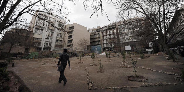 TO GO WITH AFP STORY BY CATHERINE BOITARD --- A man walks on March 17, 2009 through a makeshift park, which was once a parking lot, recently created by residents of the bohemian Athens district of Exarcheia. It is one of the most built up cities in Europe. Now fed-up residents of Athens -- enraged by the pro-development attitude of their politicians and emboldened by recent anti-government riots -- are taking matters into their own hands. AFP PHOTO/ Aris Messinis (Photo credit should read ARIS MESSINIS/AFP/Getty Images)