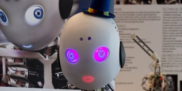 Roboy, a humanoid robot developed at the Artificial Intelligence Laboratory of the University of Zurich, mimics a kiss, at the 2014 CeBIT technology trade fair on March 9, 2014 in Hanover, central Germany. Standing at 1.2 m (3.9 ft), Roboy is designed to have the appearance of a child and to one day be used as a helper robot for the sick and elderly. Unlike more traditional robots, which have motors in their joints, Roboy is a tendon-driven robot, allowing for more fluent, human-like movements. Great Britain is partner country of the fair considered as the world's biggest high-tech fair running from March 10 to 14, 2014. AFP PHOTO / JOHN MACDOUGALL (Photo credit should read JOHN MACDOUGALL/AFP/Getty Images)