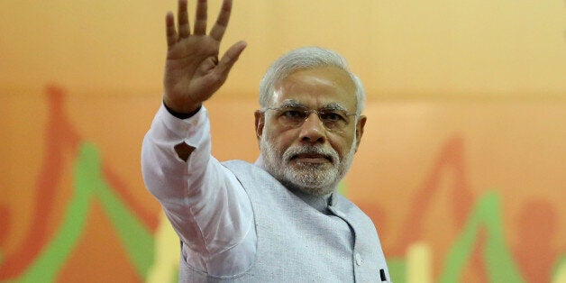 India's Prime Minister Narendra Modi waves to his supporters after addressing a rally organized by his party, the ruling Bharatiya Janata Party (BJP), in Bangalore, India, Friday, April 3, 2015. Modi's speech was mostly addressed to farmers on a day that President Pranab Mukherjee signed off on the latest version of the government's land acquisition ordinance, which proposes to ease rules for acquiring land to facilitate infrastructure projects, in a country where agriculture is the main livelihood of about 60 percent of the 1.2 billion people. (AP Photo/Aijaz Rahi)