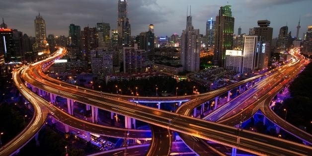 This long exposure picture shows vehicles on roads during rush hour on the eve of the National Day holidays in Shanghai on September 30, 2014. According to local media, police checkpoints will be set up at highways, elevated roads and business hubs to tackle drunk driving during the National Day holiday. AFP PHOTO / JOHANNES EISELE (Photo credit should read JOHANNES EISELE/AFP/Getty Images)