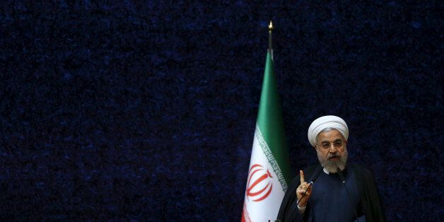 Iranian President Hassan Rouhani delivers his speech at a ceremony marking National Nuclear Technology Day, in Tehran, Iran, Thursday, April 9, 2015. Rouhani warned that Tehran will not sign on to a final nuclear deal with world powers unless it is predicated on the lifting of economic sanctions imposed on Iran over the controversial nuclear program. (AP Photo/Vahid Salemi)