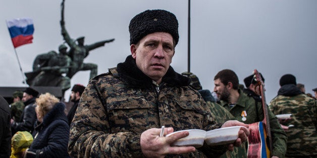 SEVASTOPOL, CRIMEA - MARCH 18: People eat food from a military canteen as they celebrate the first anniversary of the signing of the decree on the annexation of the Crimea by the Russian Federation, on March 18, 2015 in Sevastopol, Crimea. Crimea, an internationally recognised Ukrainian territory with special status, was annexed by the Russian Federation on March 18, 2014. The annexation, which has been widely condemned, took place in the aftermath of the Ukranian revolution. (Photo by Alexander Aksakov/Getty Images)