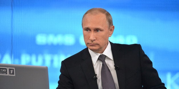 Russian President Vladimir Putin listens during an annual call-in show on Russian television "Conversation With Vladimir Puti