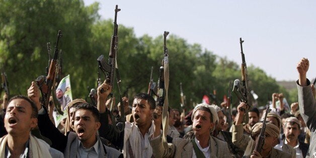 Tribal gunmen loyal to the Shiite Huthi movement raise their weapons on April 16, 2015 in the capital Sanaa during a demonstr