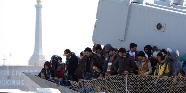 A boat transporting migrants arrives in the port of Messina after a rescue operation at see on April 18, 2015 in Sicily. A su