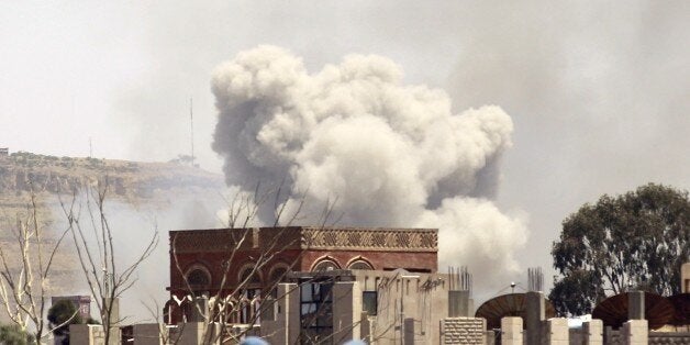 Smoke rises above the Alhva camp, east of the Yemeni capital, Sanaa, on April 17, 2015, following an alleged air strike by the Saudi-led alliance on Shiite Huthi rebels camps. Yemen's President Abedrabbo Mansour Hadi fled the country for Riyadh as the rebels supported by Iran advanced south, provoking the Saudi-led coalition to begin air strikes. AFP PHOTO / MOHAMMED HUWAIS (Photo credit should read MOHAMMED HUWAIS/AFP/Getty Images)