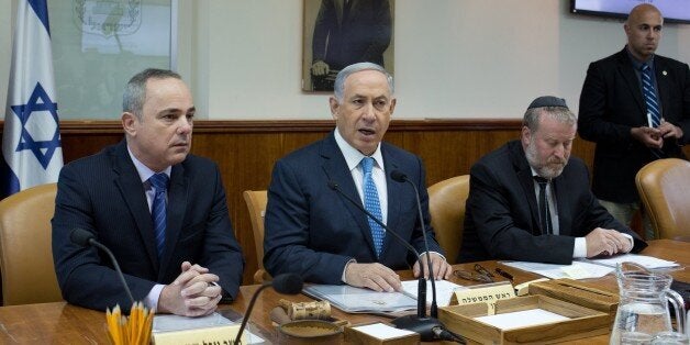 Israeli Prime Minister Benjamin Netanyahu (C) talks to the press during the weekly cabinet meeting, as he sits next to Yuval Steinitz (L), Minister of International Relations and Minister of Strategic Affairs, and Avichai Mandelblit Cabinet Secretary (R), in his Jerusalem office, on April 19, 2015. AFP PHOTO / POOL / MENAHEM KAHANA (Photo credit should read MENAHEM KAHANA/AFP/Getty Images)