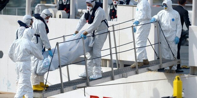 The body of a person who died after a fishing boat carrying migrants capsized off the Libyan coast, is brought ashore along with 23 others retreived by the Italian Coast Guard vessel Bruno Gregoretti at Boiler Wharf, Senglea in Malta on April 20, 2015. More than 700 people are feared dead following the capsize off Libya of a fishing boat that had been crammed with migrants trying to reach Europe. AFP PHOTO / MATTHEW MIRABELLI --- MALTA OUT (Photo credit should read Matthew Mirabelli/AFP/Getty Images)