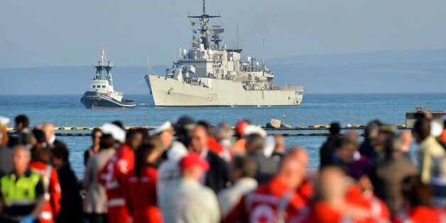 FILE - In this Tuesday, May 13, 2014 file photo, the Italian Navy frigate "Grecale", carrying victims and survivors of a migr