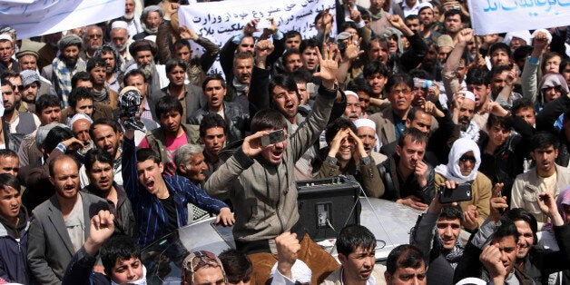 Hundreds of businessmen, shop owners and traders protest against tax hikes in Kabul, Afghanistan, Monday, April, 6, 2015. Afghan traders shut their shops in the capital Kabul on Monday and marched through the streets to protest against taxes rises in a rare public protest against the policies of the new government of President Ashraf Ghani. Some said the rise in taxes has been about 600 percent, though there are no official statistics. (AP Photo/Rahmat Gul)