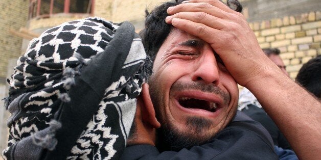 Iraqi mourners react during the funeral of a man who died in Tikrit in fighting alongside government forces against the Islamic State (IS) group, on April 11, 2015, in the southern city of Basra. AFP PHOTO / HAIDAR MOHAMMED ALI (Photo credit should read HAIDAR MOHAMMED ALI/AFP/Getty Images)