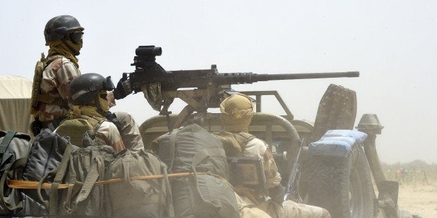 Nigerien army forces patrol in pickup trucks near Malam Fatori on April 3, 2015, after the town in north-eastern Nigeria was