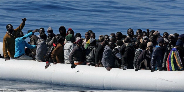 In this photo made available Thursday, April 23, 2015, migrants crowd and inflatable dinghy as rescue vassel " Denaro " (not
