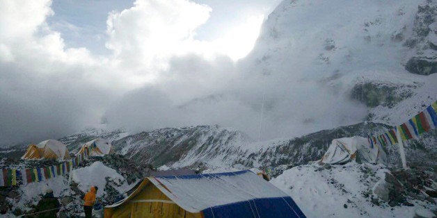 This photo provided by Azim Afif, shows a small avalanche on Pumori mountain as seen from Everest Base Camp, Nepal on Sunday,