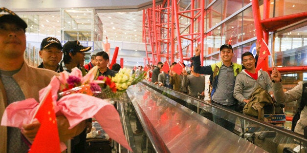 BEIJING, CHINA - MARCH 31: (CHINA OUT) 104 Chinese nationals evacuated from the Republic of Yemen arrive at the Capital International Airport on March 31, 2015 in Beijing, China. The first group of Chinese nationals have returned to China and more than 400 others will be saftely evacuated to Djibouti with the help of Chinese naval vessels, it has been reported by the China's Defense Ministry. (Photo by ChinaFotoPress/ChinaFotoPress via Getty Images)