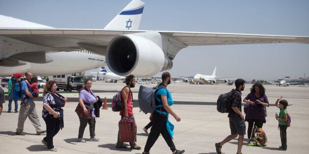 TEL AVIV, ISRAEL - APRIL 28: Israeli travelers with their new born babies from surrogate mothers in Nepal disembark from an