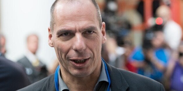 Greek Finance Minister Yanis Varoufakis waits for the International Monetary and Financial Committee (IMFC) family photo at t