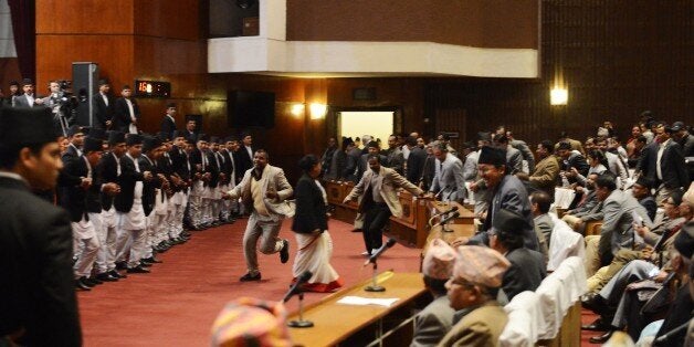 Nepalese opposition lawmakers rush to block ruling party leader Chin Kazi Shrestha (C-R) at the parliament during a constituent assembly meeting in Kathmandu on January 23, 2015. Protests by Nepal's opposition lawmakers threw parliament into chaos January 23 after emergency talks failed to secure agreement on a new national constitution before a midnight deadline expired. AFP PHOTO / PRAKASH MATHEMA (Photo credit should read PRAKASH MATHEMA/AFP/Getty Images)