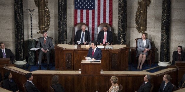 Japanese Prime Minister Shinzo Abe addresses a joint session of Congress at the US Capitol in Washington, DC, on April 29, 2015, as US Vice President Joe Biden (L) and House Speaker John Boehner listen. AFP PHOTO/BRENDAN SMIALOWSKI (Photo credit should read BRENDAN SMIALOWSKI/AFP/Getty Images)